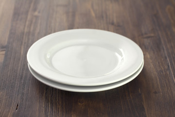 white plate on brown wooden background