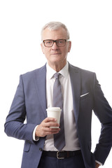 Old professional man. Shot of a senior businessman with a cup of coffee standing at isolated white background.