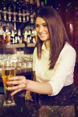 Composite image of pretty bartender serving beer 