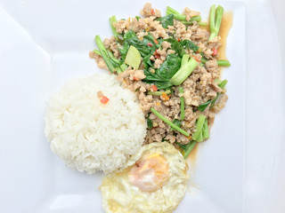 Close up Rice topped with stir fried minced pork and basil, Thai Food.