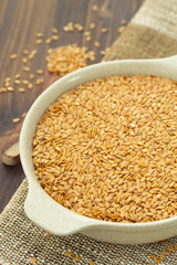 seeds on white dish on wooden background