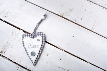 Heart with text home on the wooden background