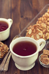 cup of tea with cookies on wooden background