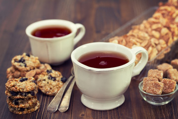 cup of tea with cookies on wooden background