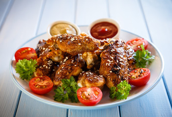 Grilled chicken wings and vegetables