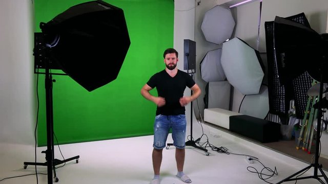 young handsome bearded man in professional photography studio - green screen 