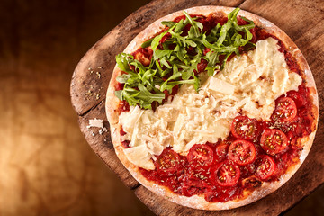 Pizza with rows of tomatoes, cheese and arugula