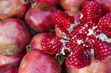 Fresh pomegranate split open to reveal the seeds on display at a Turkish juice stand 