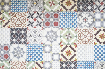 Background of jumble of mismatched tiles with vintage decorative patterns