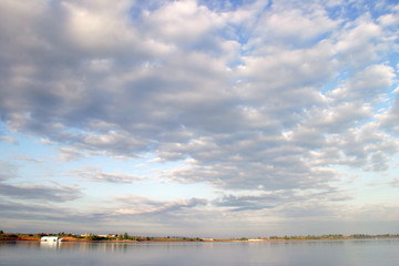 Fototapeta na wymiar Beautiful clouds over the river