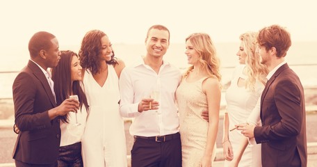 Cheerful people posing next to limousine