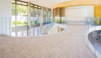 Glass wall in the office building. Modern sunny empty loft room