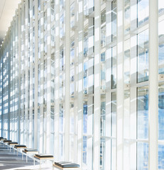 Glass wall in the office building. Modern sunny empty loft room