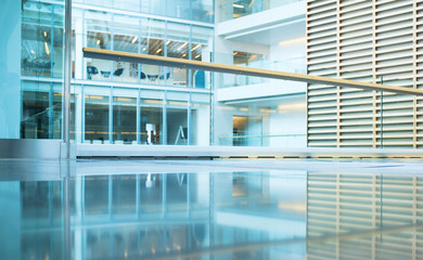 Glass wall in the office building. Modern sunny empty loft room