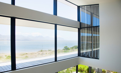 Fototapeta premium Glass wall in the office building. Modern sunny empty loft room