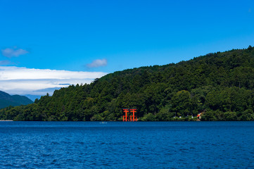 Fototapeta na wymiar Bright red Torii Gate on Ashi lake