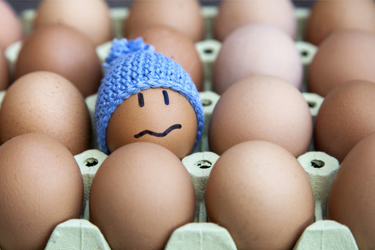 Unhappy in winter concept presented with egg character. Other possible concepts are: In troble, lost, problems, etc...