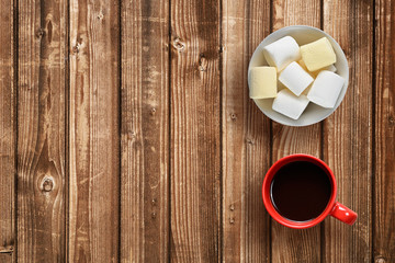 Marshmallow and coffee cup on wooden table top view