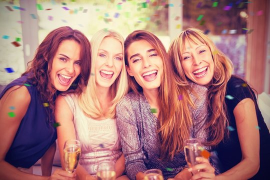 Composite image of portrait of beautiful women having drink