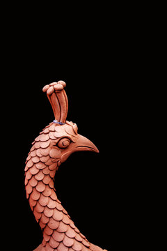 Bird sculpture on a black background.