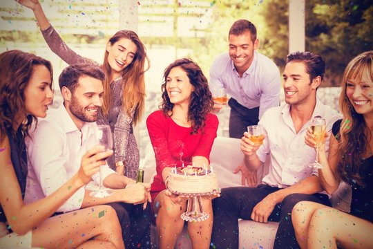 Composite image of woman celebrating her birthday with friends