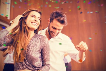Composite image of cheerful young dancing couple