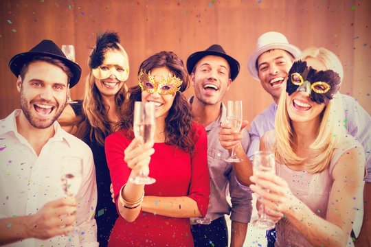 Composite image of portrait of friends holding champagne flute w