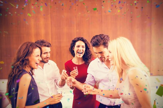 Composite image of group of friends drinking shots