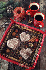 Two cup of coffee and gingerbread in basket