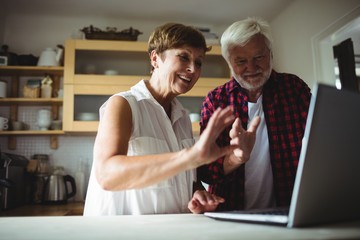 Senior couple using laptop