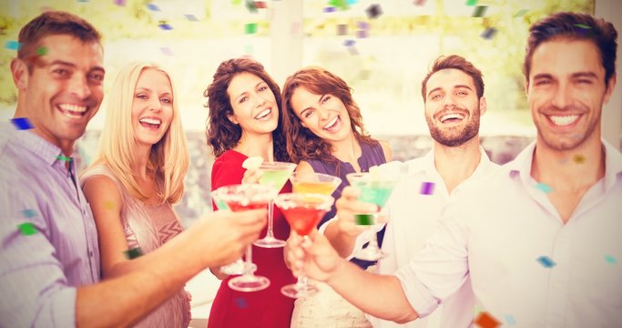 Composite image of portrait of friends having cocktail