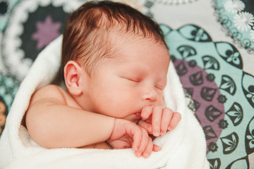 Newborn Baby is Slipping.Sweat Dreams.Cute Look with Little Hand.Selective Focus