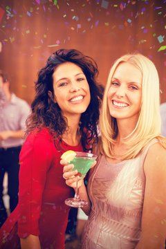 Composite image of portrait of beautiful women having drinks