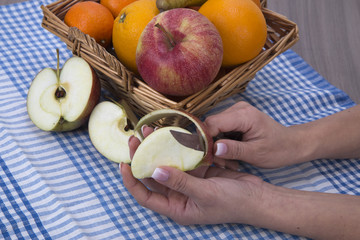 woman hands peeling an apple with a knife
