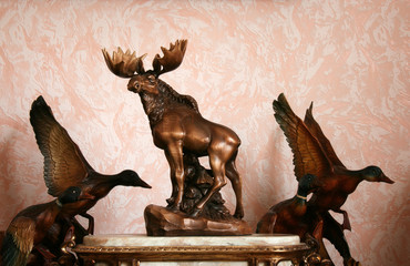 Wooden figurines of elk and mallards
