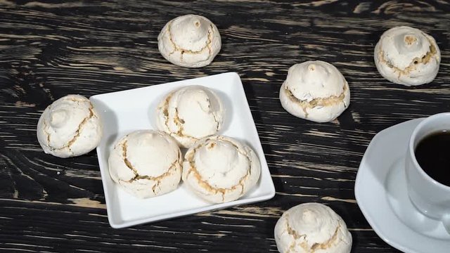 lot of white meringue cakes with coffee