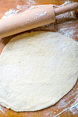 Preparation of the Dough on Wooden Background with Rolling Pin, Flour and Free Space for Text, Vertical Top View