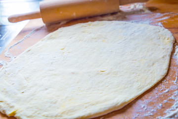 Fresh Dough on Wooden Table with Rolling Pin