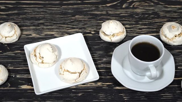 lot of white meringue cakes with coffee