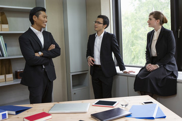 窓辺で話すビジネスパーソン