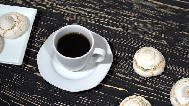 lot of white meringue cakes with coffee