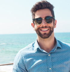 young man smiling in the beach