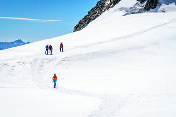 Naklejka na ściany i meble Mountaineers walking on the summit of Mont Blanc