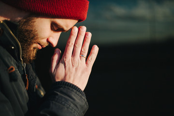 Man praying outside to God - obrazy, fototapety, plakaty
