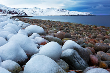 Beach with big round stones on the coast of the Barents Sea, Arctic