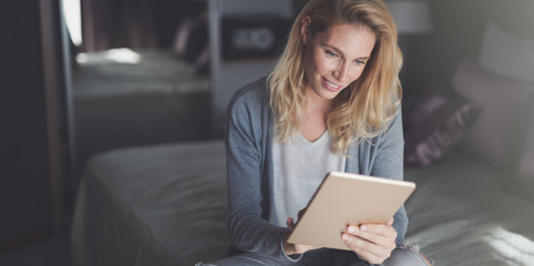 Blond woman using tablet