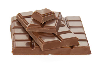 Stack of different pieces milk chocolate isolated on white background.