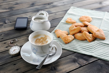 Foods of the Italian breakfast with coffee milk and biscuits on an old wooden table