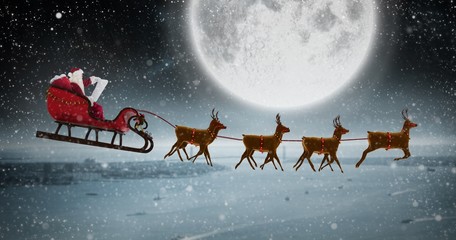 Composite image of side view of santa claus riding on sleigh dur
