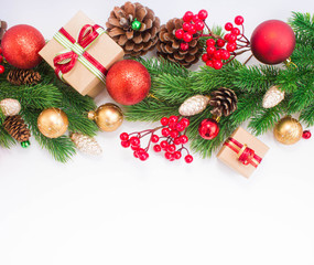 Christmas or New Year background: fur-tree, branches, gifts, colored glass balls, decoration and cones on a white background